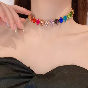 Close-up detail of a colorful teardrop crystal choker necklace worn by a fashion model
