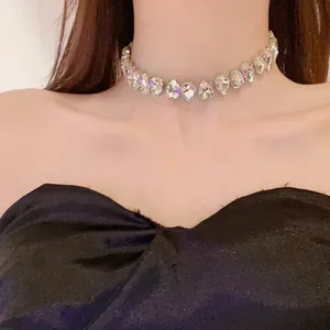 Detailed view of a sparkling teardrop crystal choker necklace on a female model.