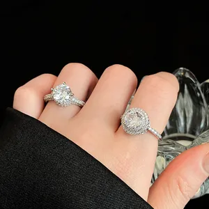 Elegante zilverkleurige ronde zirkoon ringen met pavé steentjes getoond op een hand tegen zwart