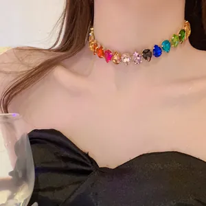 Detailed close-up of a colorful teardrop crystal choker necklace worn by a female model