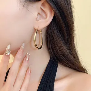 Elegant gold plated oval U-shaped hoop earrings for women with a minimalist aesthetic