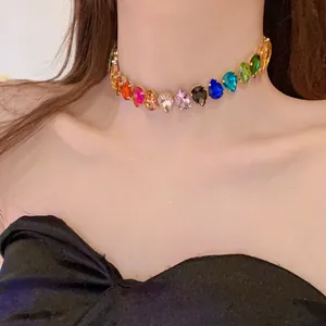 Close-up detail of rainbow crystal teardrop choker necklace elegantly worn on model
