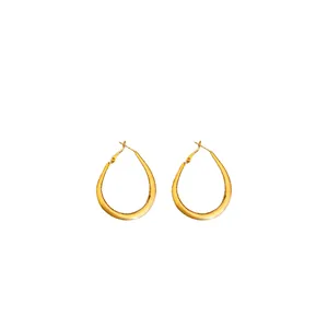 Minimalist gold-plated oval U-shaped hoop earrings for women on white background