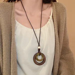 Close-up of a vintage ethnic style long necklace with wood and resin geometric circles.