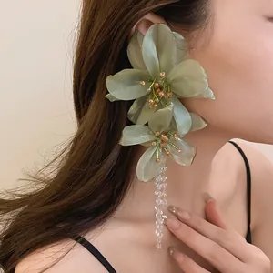 Elegant oversized green mesh flower earrings with crystal tassels for party wear