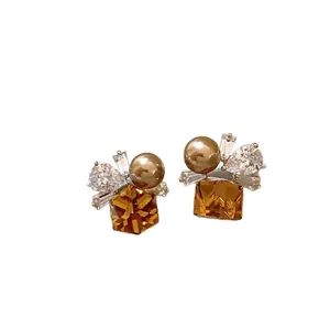 Elegant square amber gemstone earrings with pearls and clear crystals on a white background