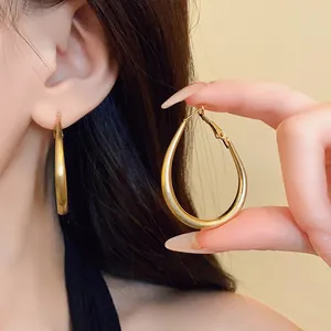 Elegant gold-plated large oval U-shaped hoop earrings with matte brushed finish for women