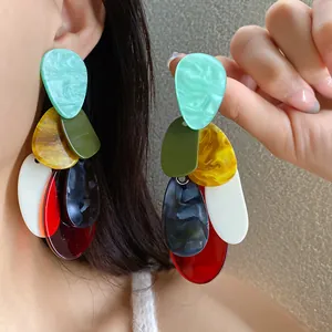 Detailed view of oversized vintage acrylic drop earrings featuring colorful marble textures