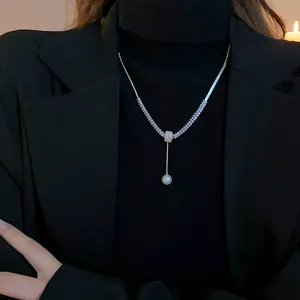 Elegant pearl and zircon drop necklace detail shown on a model for bridal wear