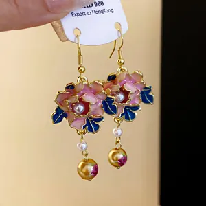 Detailed view of French vintage floral dangle earrings with drip oil petals and pearls.