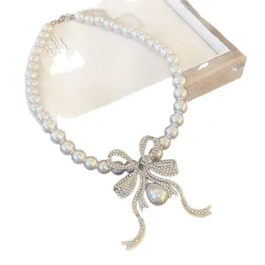 Elegant French style pearl necklace with rhinestone bow and teardrop pendant.