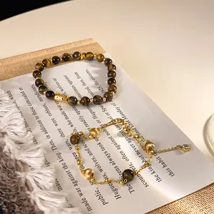Detailed view of luxury gold-plated tiger eye stone bracelet set with vintage aesthetic