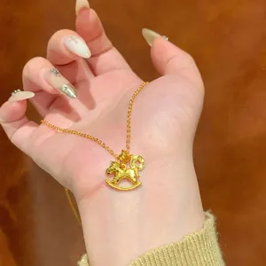 Gold rocking horse pendant necklace with a hammered finish and delicate chain.