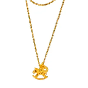 Elegant golden rocking horse pendant necklace with fine chain on white background