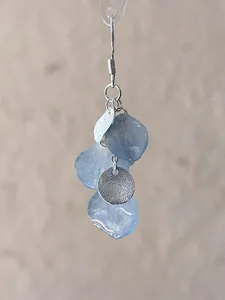 Elegant gradient blue petal earrings with textured silver circular charms detail