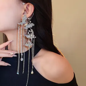 Elegant zircon-encrusted butterfly ear cuff with long shimmering tassels for evening dresses.