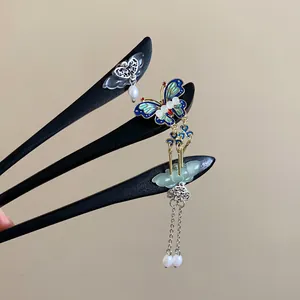 Detailed view of three elegant Chinese butterfly wooden hairpins for Hanfu accessories