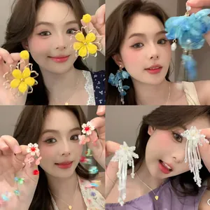 Collage of elegant fabric flower earrings in various colors worn by a model.