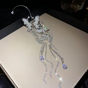 Close-up detail of silver butterfly ear cuff featuring sparkling long zircon tassels