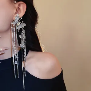 Close-up of sparkling zircon butterfly tassel ear cuff with silver rhinestone chains