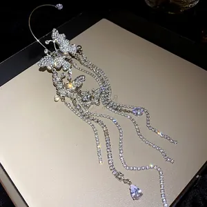 High-detail macro shot of a sparkling zircon butterfly tassel ear cuff with crystals