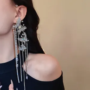 Detailed shot of sparkling zircon butterfly ear cuff featuring long elegant rhinestone tassels