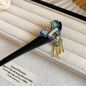 Macro view of the blue enamel butterfly detail on a vintage Chinese wooden hair stick