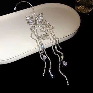 Detailed close-up of elegant silver butterfly tassel ear cuff with sparkling zircon stones