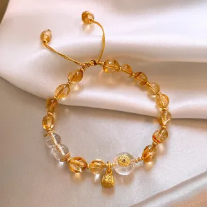 Vista dettagliata di un bracciale vintage in agata e pietra del sole su seta bianca.