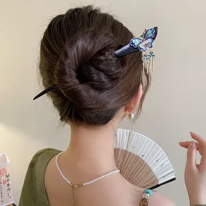 Close-up view of a New Chinese style wooden hairpin with a delicate butterfly design