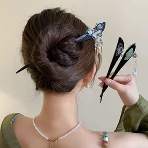 Vintage New Chinese style wooden hairpins featuring elegant butterfly and floral dangle charms