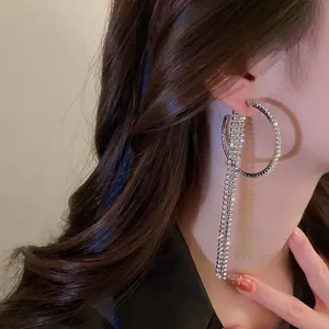 Detailed macro view of sparkling rhinestone tassel hoop earrings for elegant evening wear
