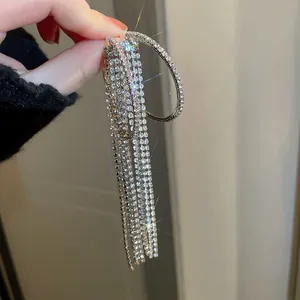 Close-up of elegant silver-colored tassel earrings with shimmering rhinestones detail