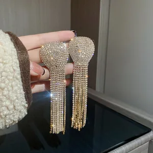 Detailed macro view of long bridal tassel earrings with shimmering full rhinestone pave