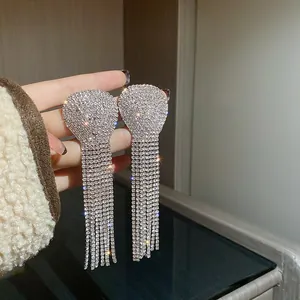 Detail showing elegant silver-tone full diamond tassel earrings for evening gala
