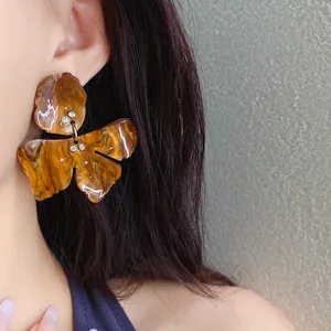 Macro view of vintage amber resin flower earring with sparkling rhinestone details