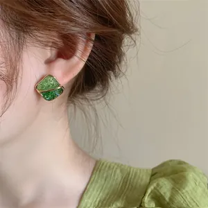 Close-up of elegant square color-blocked crystal earrings with silver needle studs