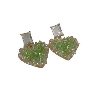 Elegant gold-tone heart-shaped drop earrings featuring green and clear faceted crystals