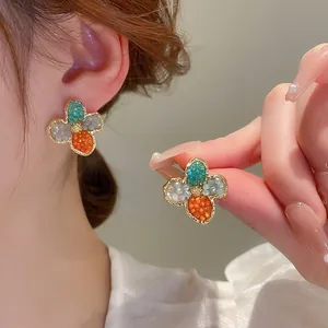 Close-up macro view of colorful crystal flower earrings featuring delicate micro-bead detailing
