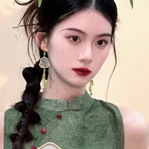 Elegant New Chinese style bamboo earrings with ink painting detail on Asian model.