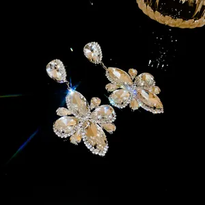 Dettaglio di eleganti orecchini pendenti con fiori di cristallo scintillante in argento