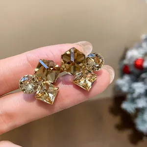 Gros plan de clips d'oreilles élégants dorés avec cristaux champagne