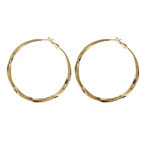 Stylish gold-tone oversized twisted hoop earrings with silver needle posts for women