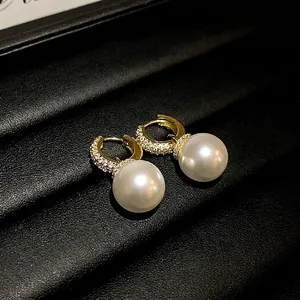 Elegant gold-plated hoop earrings featuring pavé zircon and large white pearl drops