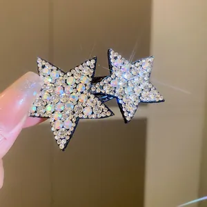 Detailed macro view of Y2K style star hair clip with sparkling iridescent rhinestones