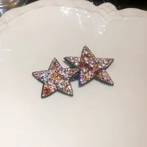 Exquisite sparkling rhinestone star hair clips with Y2K style details on white porcelain