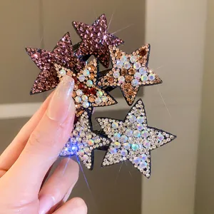 Detailed close-up of sparkling rhinestone star-shaped BB hair clips in trendy Y2K style.