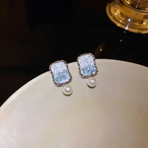 Elegant silver-tone square earrings featuring blue crushed crystals and pearls.