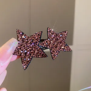 Close-up macro view of a sparkling star-shaped hair clip with purple rhinestones