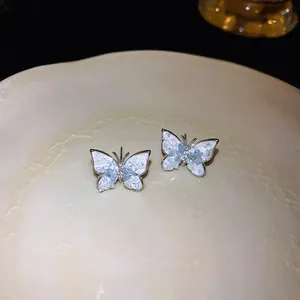 Close-up of elegant butterfly stud earrings with detailed crushed ice crystal texture